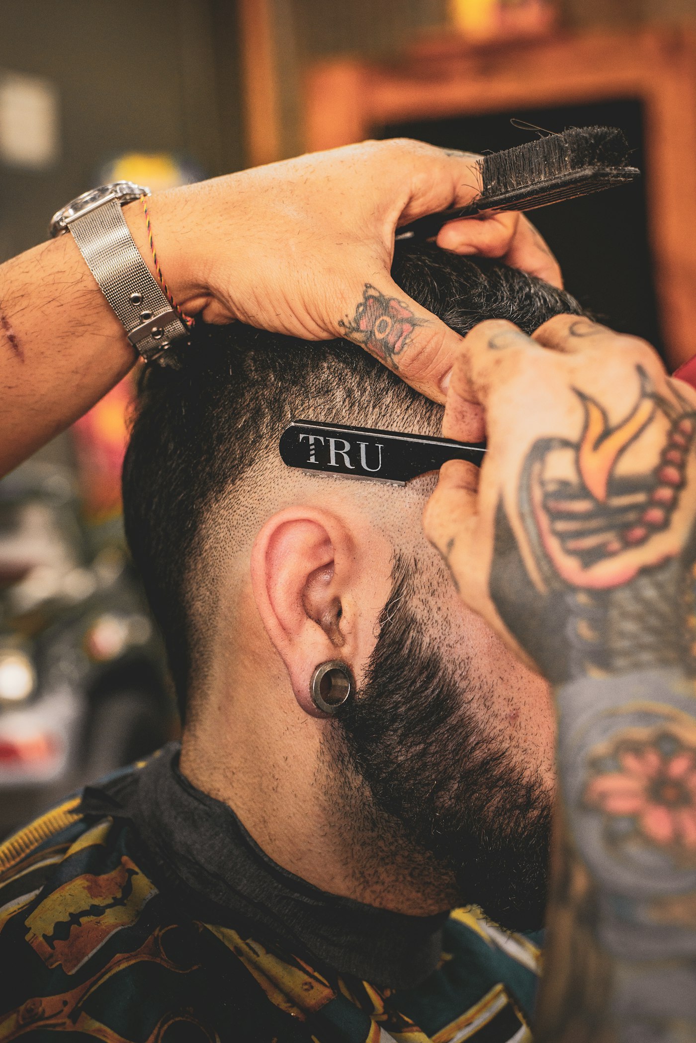 Illustrative razor detail at the side of a man’s haircut; not Golden Scissors staff or work