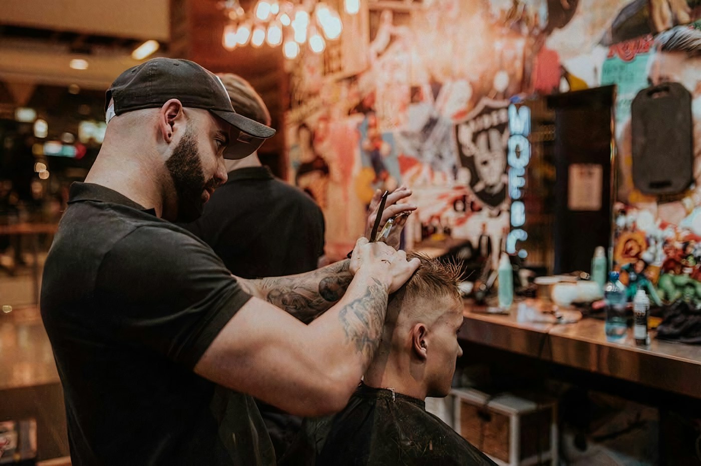 Illustrative photograph of a barber cutting a man’s short hair with scissors; not Golden Scissors staff, customers or work